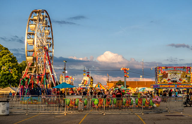 photographic image of The Ohio State Fair at dusk just inside the 11th avenue gate